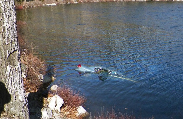 A car sinks in Fox Pond in Hancock County on Saturday. Maine State Police photo