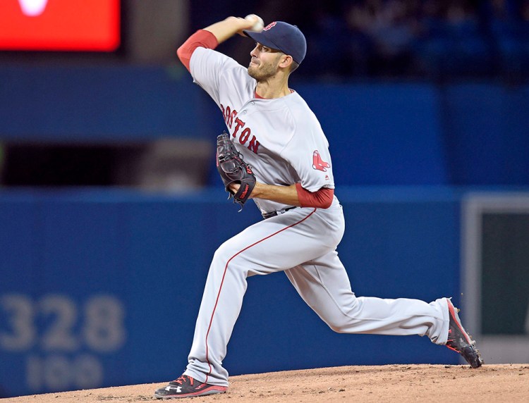 Boston's Rick Porcello works against the Blue Jays during the first inning of Saturday's game in Toronto. He allowed four runs and seven hits in six innings to notch the win. Frank Gunn/The Canadian Press via AP