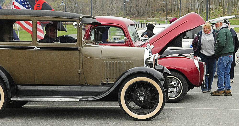 People look over cars during the first Classic Cruise-In Night on Thursday at Gardiner Waterfront Park.