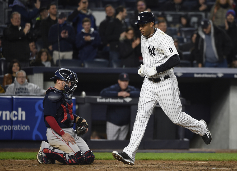 The Yankees' Aaron Hicks crosses home plate after hitting a seventh-inning solo home run off Red Sox starter Rick Porcello. The home run proved to be the difference in a 3-2 win for the Yankees.