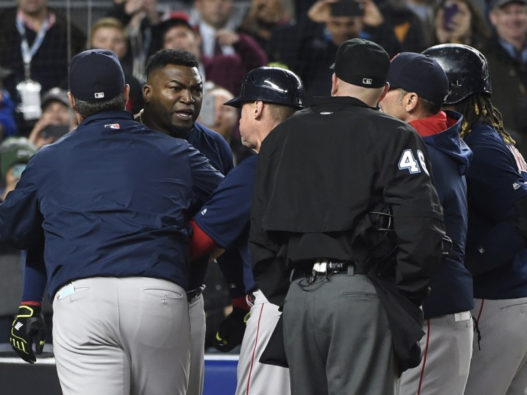 Boston Red Sox manager John Farrell, left, and teammates push David Ortiz away from umpire Ron Kulpa as Ortiz disputes a called second strike in the ninth inning. Both Farrell and Oritiz were ejected from the game.