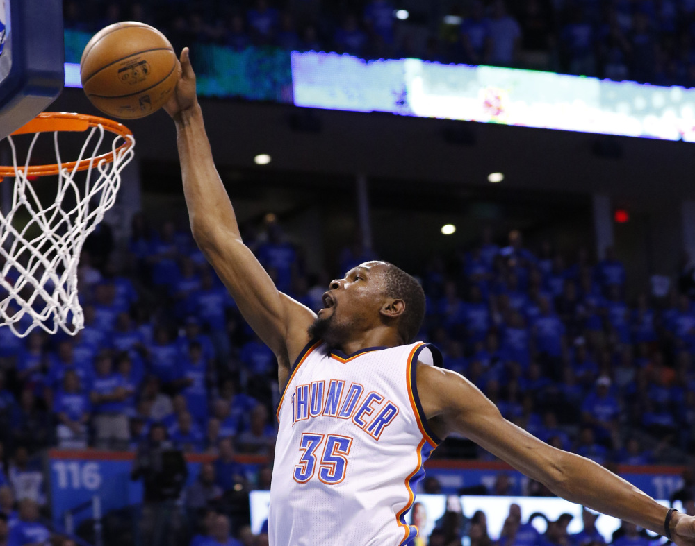 Thunder forward Kevin Durant dunks in the first quarter of Game 6  against the Spurs Thursday night in Oklahoma City.