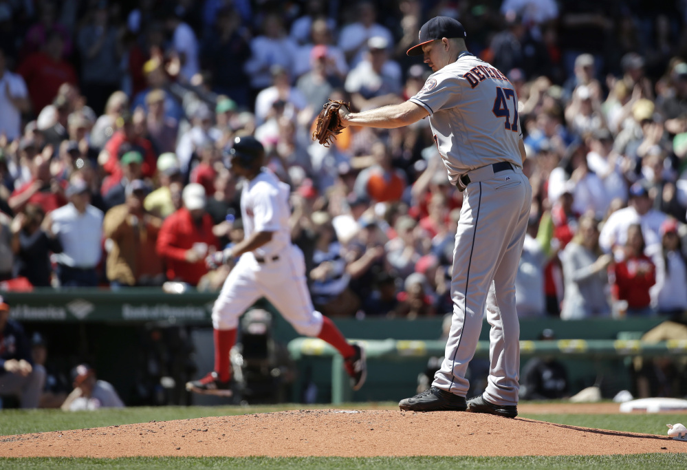 Xander Bogaerts, left, rounds the bases after hitting a three-run homer off Houston's Chris Devenski, right, in the second inning.