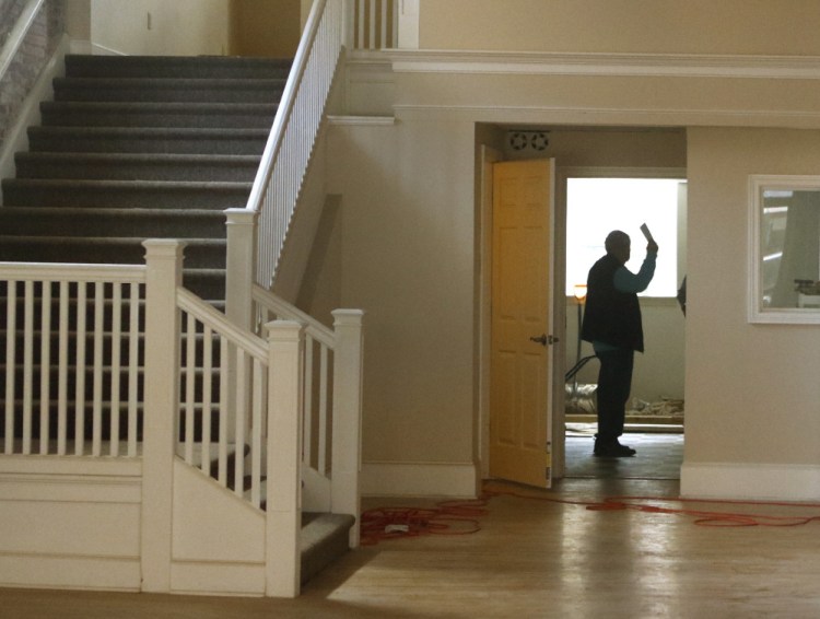 Electrical inspector Roger Jalbert of Biddeford's Code Enforcement Office checks the ground floor of an apartment building. The office has inspected six buildings so far and found only minor violations.
Gregory Rec/Staff Photographer