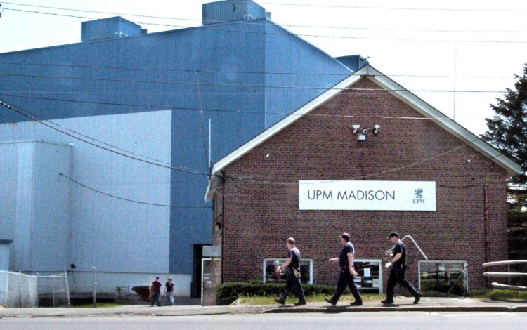 Mill workers carry tools into the Madison Paper Industries mill in Madison on Monday. The mill ended production last Saturday and will close.