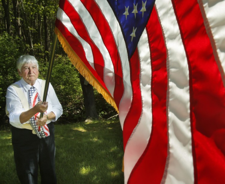 Marion Alexander of Scarborough has been carrying the flag in Portland parades since 1982. "I'll do it as long as I can," she said.