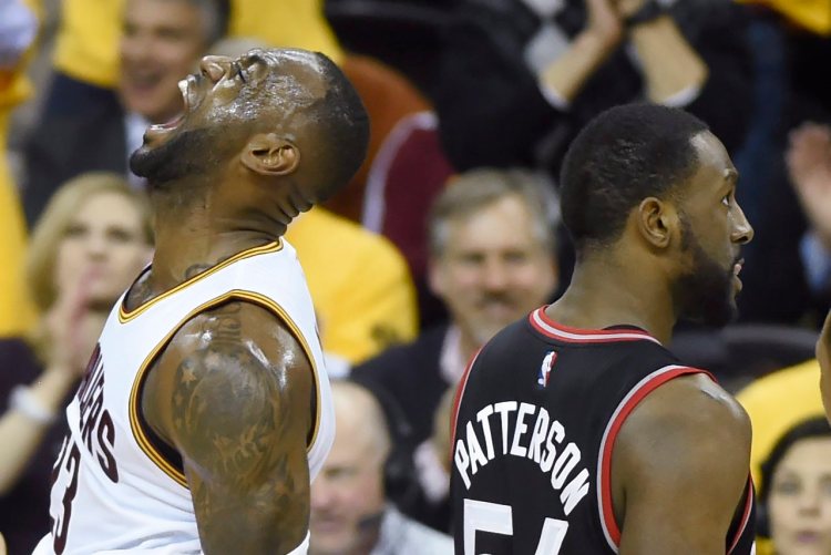 Cleveland's LeBron James celebrates after a thunderous dunk against the Toronto Raptors on Tuesday.   The Associated Press