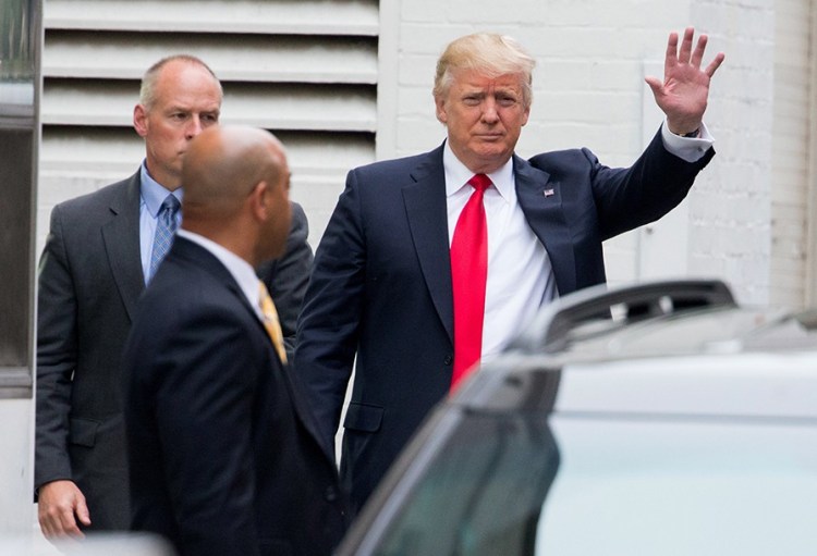 Republican presidential candidate Donald Trump waves as he arrives for a meeting with House Speaker Paul Ryan at the Republican National Committee Headquarters on Capitol Hill Thursday. The Associated Press