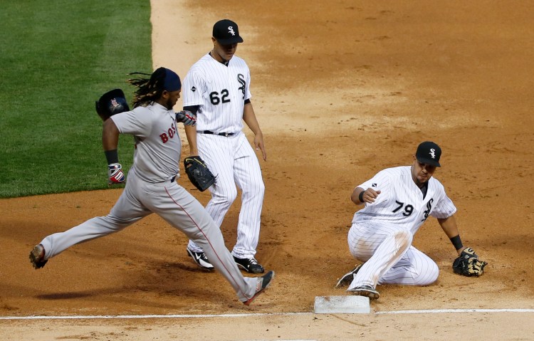 Chicago first baseman Jose Abreu gets to the bag before Boston's Hanley Ramirez as the Red Sox only managed four hits in a 4-1 loss Tuesday.   The Associated Press