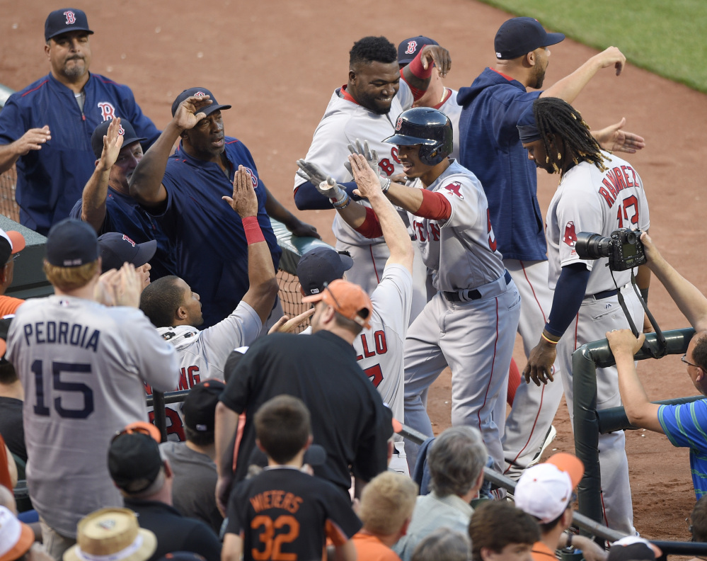 Boston's Mookie Betts, right with batting helmet, celebrates his home run with Hanley Ramirez and others during the second inning of Wednesday's game at Baltimore.