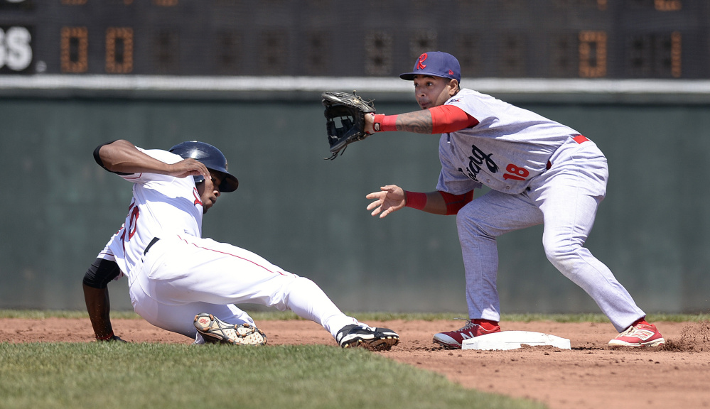 Rainel Rosario of the Portland Sea Dogs slides back to second base as Angelo Mora of the Reading Fightin Phils waits for the throw from the pitcher on a pickoff attempt. Reading swept the three-game series at Hadlock Field.