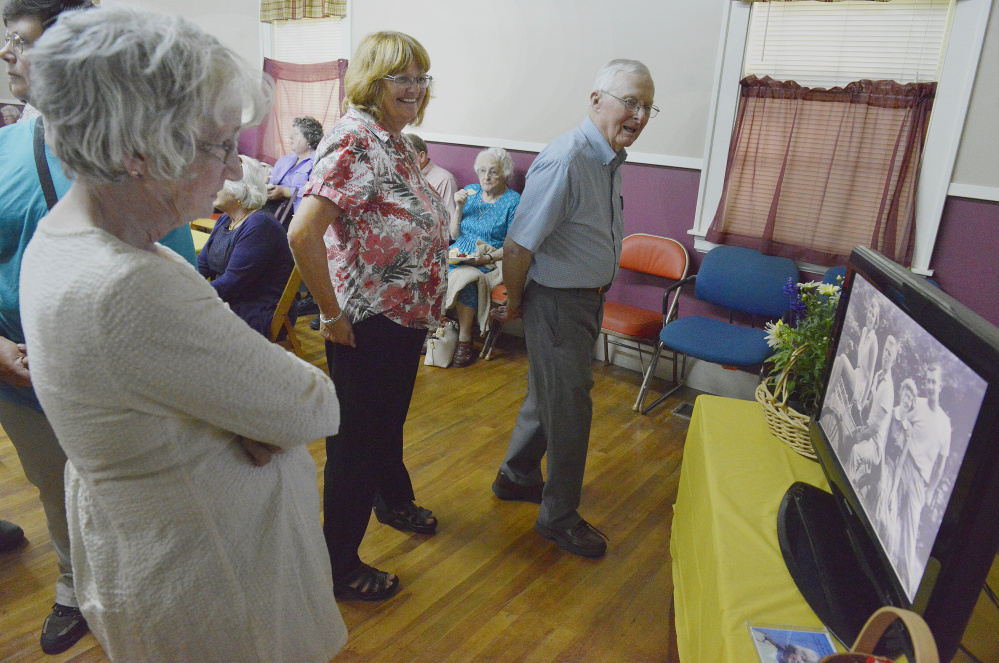 At a celebration of Nancy Randall Clark's life, attendees watch a slide show about the former lawmaker. Clark also taught at Freeport High School and was very active in the community.