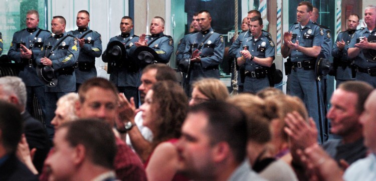 Maine State Police troopers from  around the state and family members applaud award winners during a ceremony at the Maine Criminal Justice Academy in Vassalboro on Tuesday.