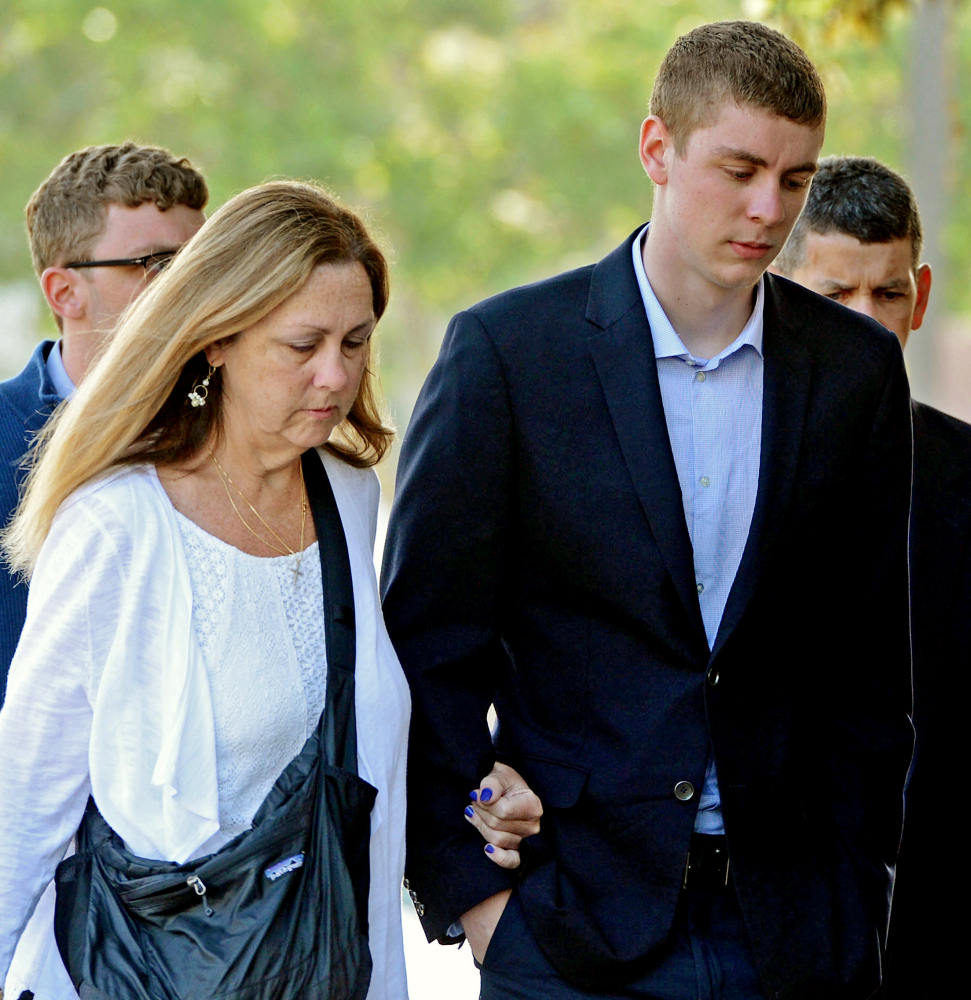 Brock Turner, right, makes his way into the Santa Clara Superior Courthouse in Palo Alto, Calif., on June 2. A letter written by Turner's father was made public by a Stanford law professor who wants the judge in the case removed from office because of Brock Turner's six-month sentence.