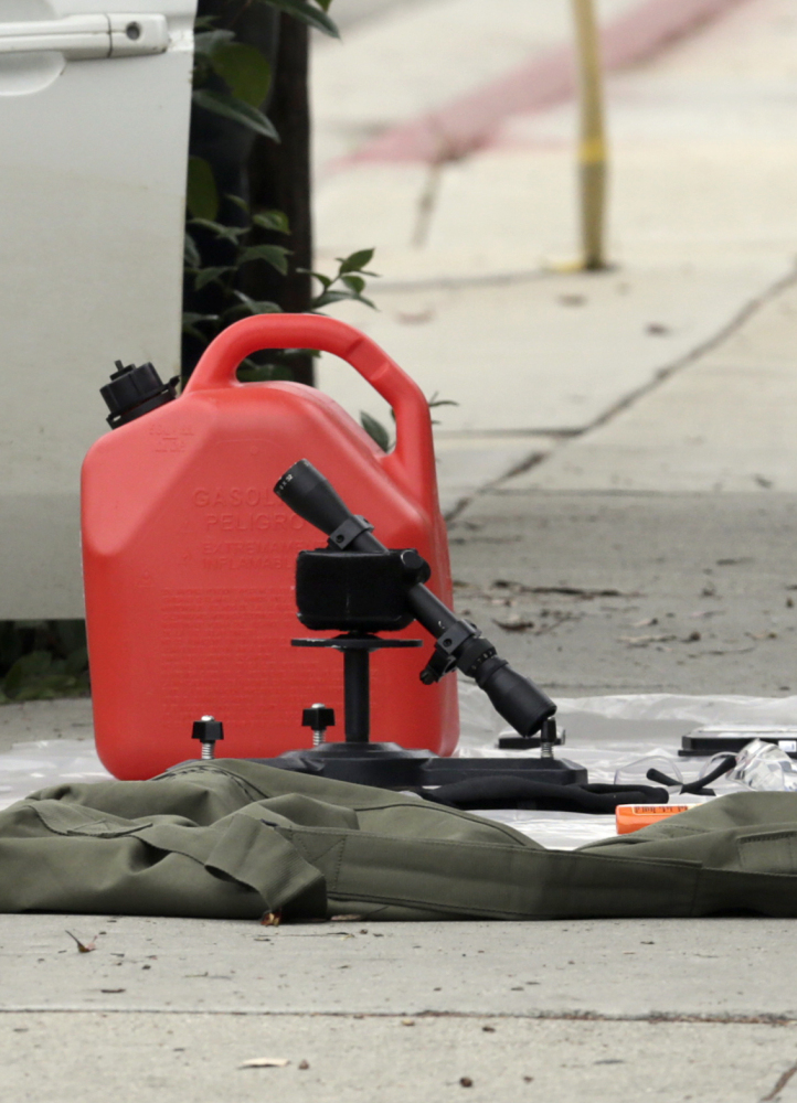 Items removed from a car are displayed on a sidewalk after a heavily armed man was arrested in Santa Monica, Calif., on June 12.