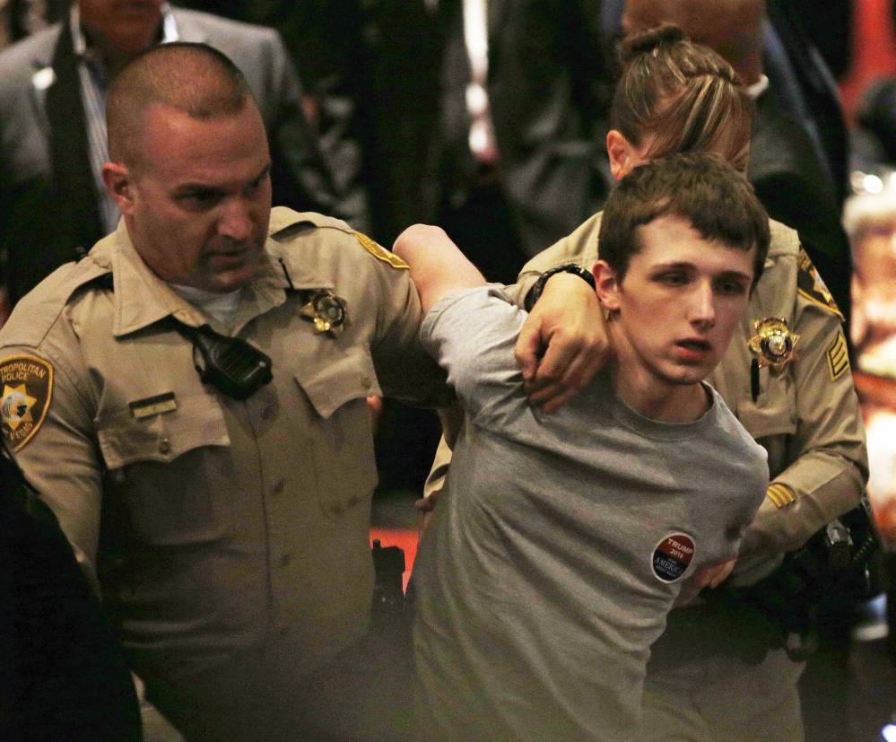 Police remove Michael Steven Sandford as Republican presidential candidate Donald Trump speaks Friday in Las Vegas. Sandford is accused of trying to take a police officer's gun with the goal of killing Trump.