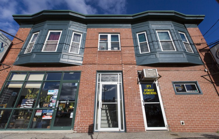 David Munster's TV store, left, and Forest Gardens share a building on Forest Avenue whose future depends on rezoning  and historic landmark status.   Ben McCanna/
Staff photographer