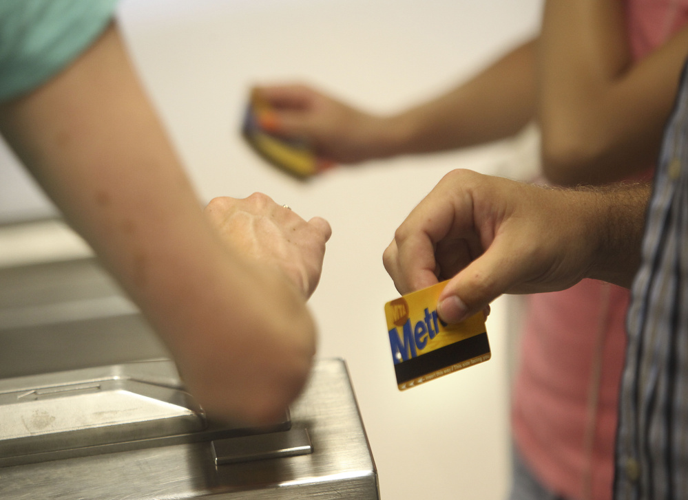 Subway riders swipe their metrocards through the turnstiles in New York, Wednesday, July 28, 2010. New York's transit agency is proposing fare increases of more than 16 percent for monthly subway and bus passes and 9 percent hikes on suburban trains, another blow to commuters still getting used to service cuts last month that eliminated some subway and bus routes.  (AP Photo/Seth Wenig)