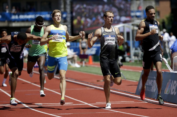 Boris Berian, right, wins his heat while Lewiston's Isaiah Harris, far left, leans across the finish line for the 800-meter run. Harris' effort earned him a spot in Monday's final.