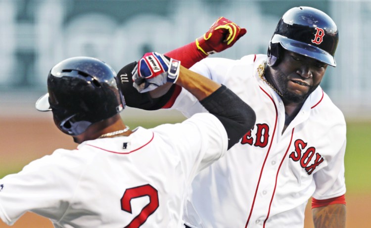 David Ortiz celebrates with Xander Bogaerts after his two-run home run off Texas Rangers starter Martin Perez in the first inning Wednesday night at Fenway Parl. The homer gave Ortiz his 15th straight season with 20 or more home runs.