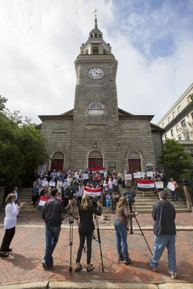 Reporters cover the vigil at First Parish Church in Portland on Sunday.
Ben McCanna/Staff Photographer