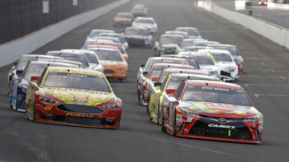 Kyle Busch, right, leads Joey Logano, left, and the rest of the field Sunday on the final restart of the Brickyard 400 at Indianapolis Motor Speedway. Busch led 149 of 170 laps as he became the first driver to sweep the Xfinity Series and Sprint Cup poles and races on the same weekend.