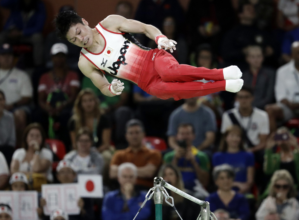 Japan's Kohei Uchimura performs on the horizontal bar Wednesday, on his way to his second straight Olympic title.