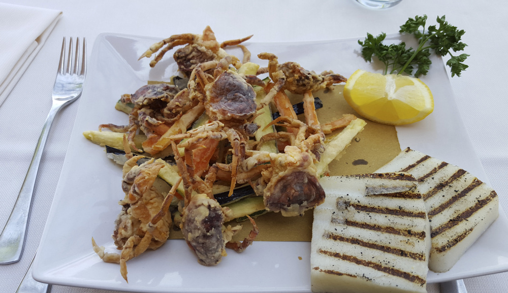 Moleche, or deep-fried soft-shell green crabs, is served up in Venice, Italy. Some hope their nearly identical Maine cousins, reviled for decimating clam flats and preying on mussels and scallops, can be exploited in similar ways.