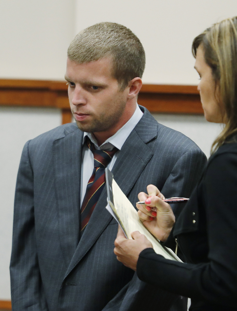 Kenneth Briggs Jr., 27, listens to attorney Heather Gonzales during a hearing Monday at the Cumberland County Courthouse in Portland. Briggs is charged in the fatal stabbing of Roger Nelsen, who was found at the Wal-Mart parking lot in Falmouth.