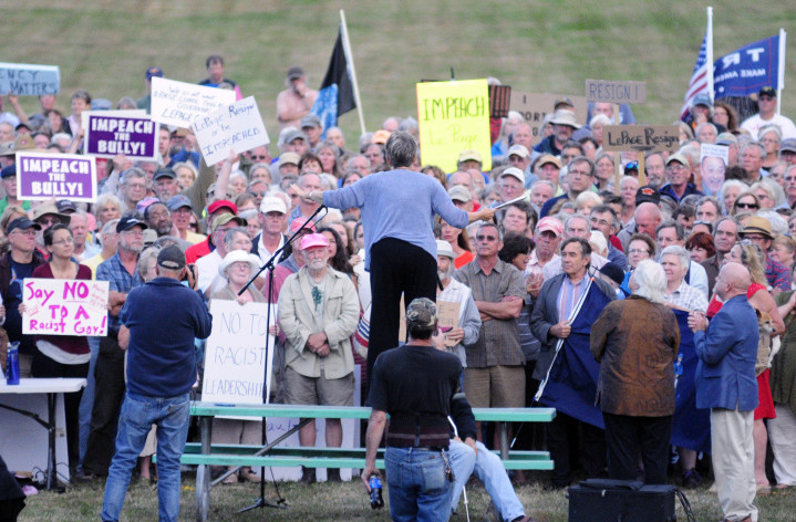 Anti-bullying activist Betsy Sweet stands on a picnic table to give a speech Tuesday in Augusta's Capital Park, where hundreds of people rallied for Gov. LePage to either resign or get help.