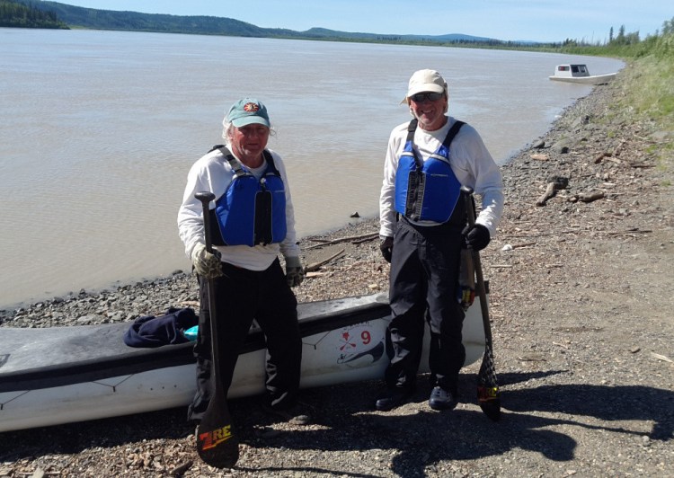 Terry Wescott, left, of Thorndike and Brad Krog, right, of Bowdoin stand ashore beside the Yukon River near Fairbanks, Alaska, after finishing the Yukon 1000 and becoming the first canoe team, as well as the oldest team, to win the endurance wilderness race.