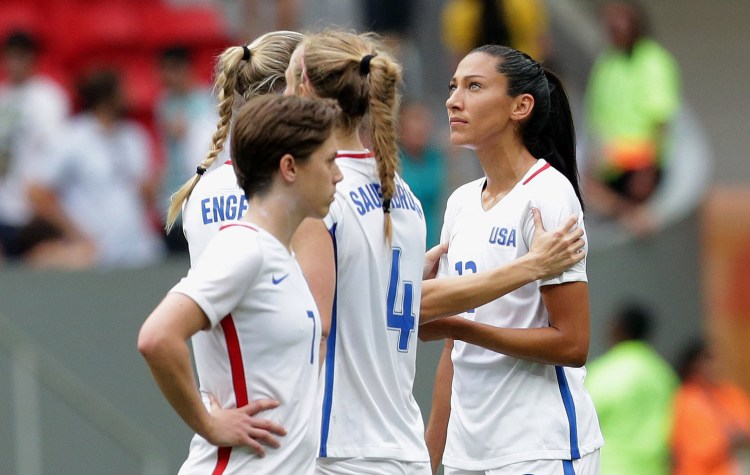 United States' Christen Press is comforted by a teammate after missing a penalty kick during a shoot-out against Sweden at a quarterfinal match of the women's Olympic football tournament in Brasilia on Friday. The United States was eliminated by Sweden.