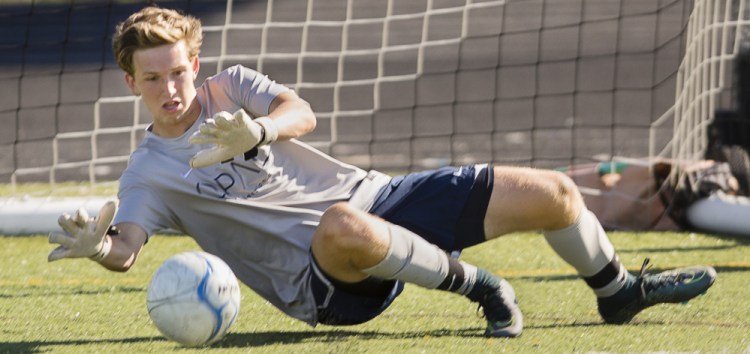 Goalkeeper Chris Franklin goes down to make a save during practice as Scarborough prepares to defend its Class A South championship. The Red Storm will be attempting to make up for the loss of eight of their 11 starters to graduation.