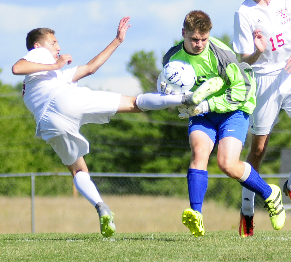 Cony's Bradley Houston, left, tries to follow up on a rebound as Lawrence keeper Alexander Owens tries to hang onto the ball Friday in Augusta.