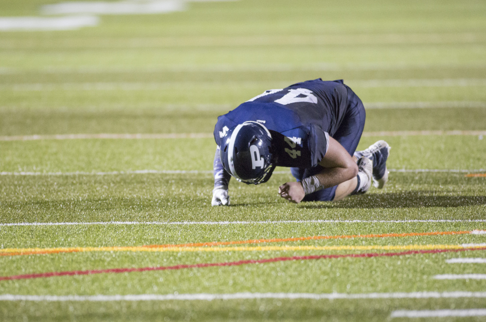 Brianna Soukup/Staff Photographer
Portland's Ethan Hoyt, 44, stays on the ground after missing a pass in the last seconds of Friday's game against Scarborough at Fitzpatrick Stadium.