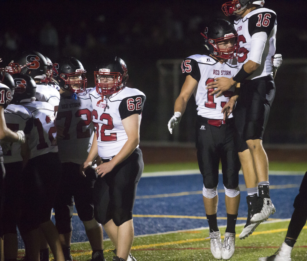 Scarborough players celebrate after winning the opener at Portland, 14-13.