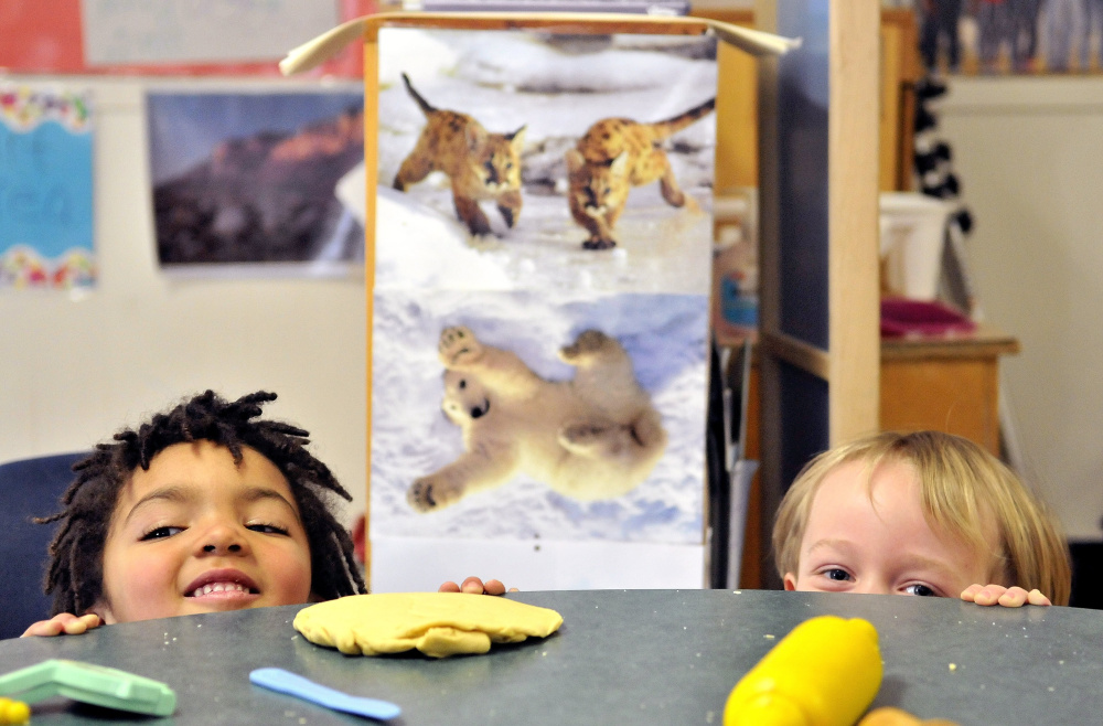 Mckyah Pooler, 3, left, and 4-year-old Devon Wilbur play peek-a-boo during preschool activities at the Maine Children's Home for Little Wanderers in Waterville. The types of challenging behaviors that are likely to lead to expulsion – hitting, pushing, biting – occur in 92 percent of Maine child care centers and preschools.