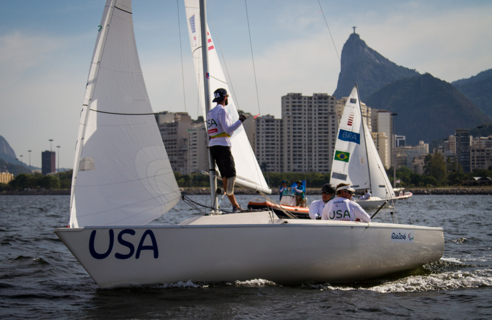 Hugh Freund, left, looks back toward Rio de Janeiro, as he and crewmates Rick Doerr and Brad Kendell sail their keelboat. “Sailing’s a huge mental game,” he said, noting “We were in a tricky spot.” Will Ricketson/US Sailing