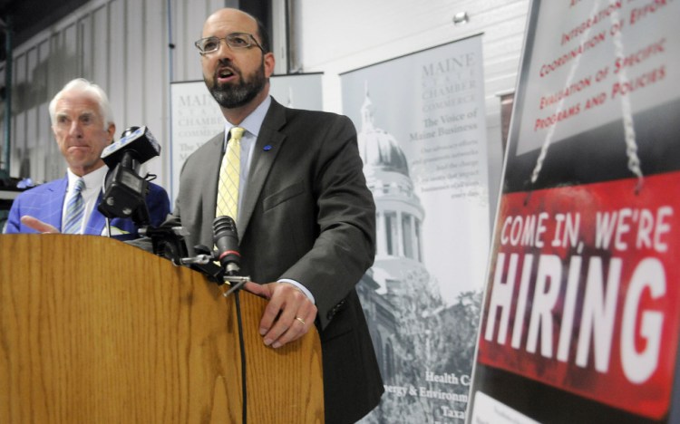 Maine Development Foundation President Yellow Light Breen, at lectern, and Maine State Chamber of Commerce President Dana Connors discuss a report on recruiting immigrants Thursday in Augusta. They called for expanding efforts to help them integrate into society and the workplace.