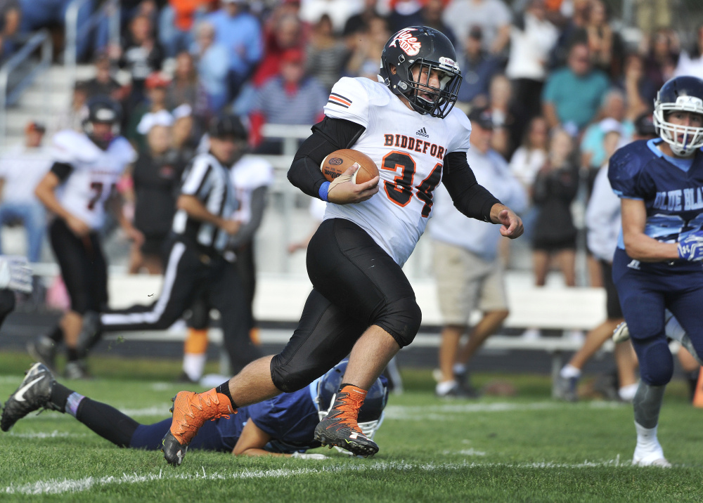 Brady Crepeau powers through the Westbrook secondary on his way to a long gain in the third quarter. He rushed for 140 yards and two TDs.