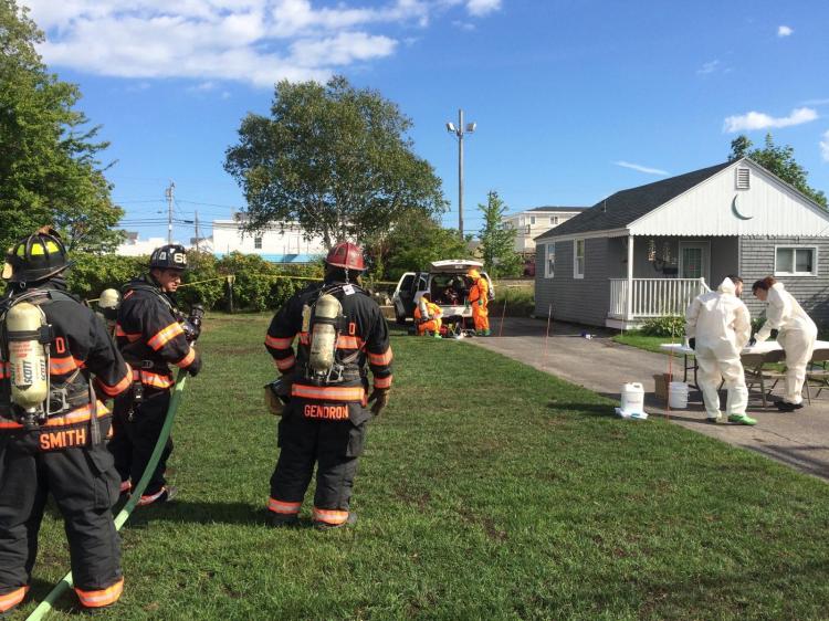 Fire and police personnel work at the Old Orchard Beach address where a meth lab was found inside a car. 