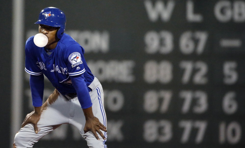 Toronto's' Melvin Upton Jr. blows a bubble after stealing second base during the fourth inning of a baseball game against the Boston Red Sox in Boston on Saturday.