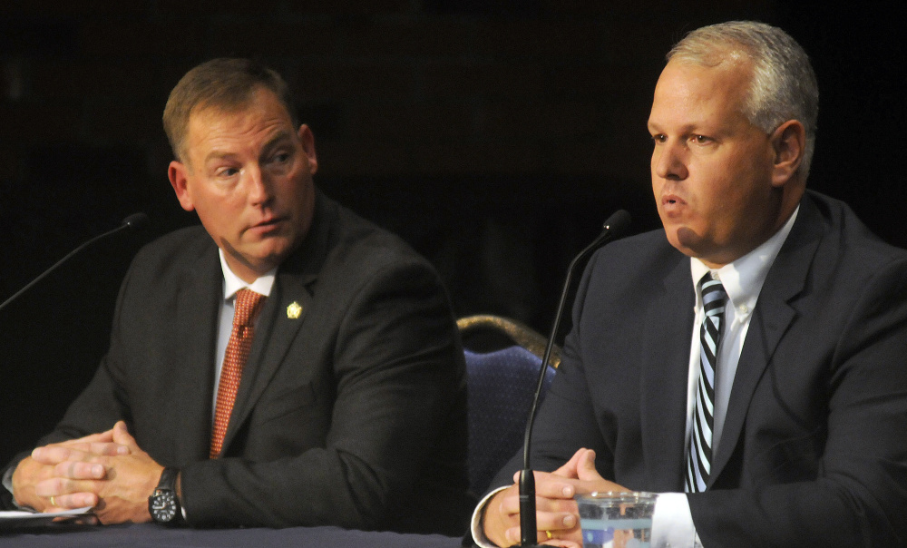 Ken Mason, left, listens Oct. 24 as Kennebec County Sheriff Ryan Reardon responds to a question during the debate between the two candidates sheriff in Augusta.