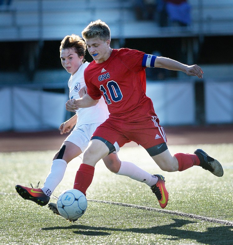 Yarmouth's John Clinton battles for the ball with Bryce Hayman of Gray-New Gloucester on Tuesday.    Shawn Patrick Ouellette/Staff Photographer