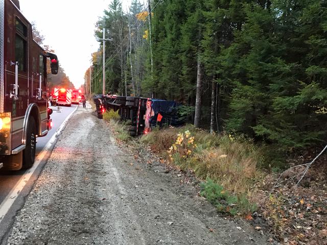 A logging truck rolled over Monday on Route 121 in Casco, causing a shutdown of the road.