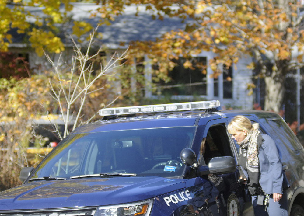 Police officers confer outside the Balcer residence in Winthrop, where the bodies of Antonio and Alice Balcer, both 47, were found Oct. 31.