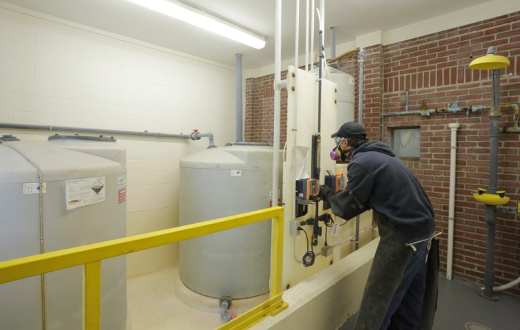 KENNEBUNK, ME - OCTOBER 5: Randy Nichols checks the feed rate of hydrofluorosilicic acid, a type of fluoride in tanks at left, as it is added to water at the Kennebunk, Kennebunkport and Wells Water District. A forum will be held Monday in Kennebunk to discuss an upcoming referendum in seven towns that asks residents if they want to continue to add fluoride to drinking water. (Photo by Gregory Rec/Staff Photographer)