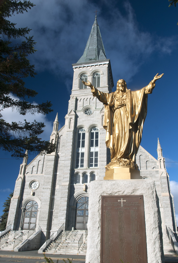 St. Augustine Church in Augusta is celebrating the centennial of the church building opening with a special Mass on Nov. 19. The plaque under the statue lists names of parishioners who served in World War I.