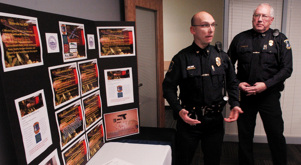 Waterville Deputy Police Chief Bill Bonney, left, and Chief Joe Massey speak beside a display of opiate drugs and statistics on the increase of drug use after announcing a new program called Operation HOPE, Heroin Opiate Prevention Effort, at a news conference Wednesday. The program combines enforcement, education and treatment for drug users.