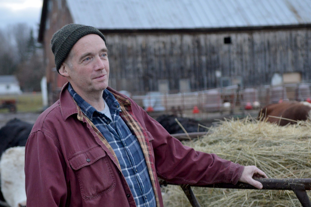 Scott Greaney feeds livestock as his two sons finish their chores at Greaney's turkey farm. His family saw his recent illness as a chance to show what he means to them.